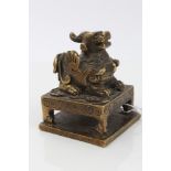 Chinese Qing period bronze official's seal with winged beast mount, seated on a table,