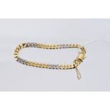 Yellow and white metal curb link bracelet with diamond set links