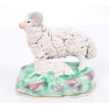 19th century Staffordshire porcelain group of a ram and lamb, on naturalistic base,