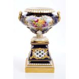 Royal Worcester porcelain urn with twin gilt handles, fruit reserve on blue and gilt ground,