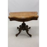 Mid-Victorian figured walnut and marquetry line-inlaid serpentine card table raised on bulbous