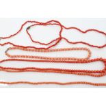 Five coral bead necklaces - various - to include 1920s coral bead necklace with faceted glass bands