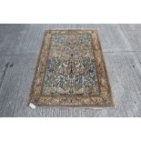 Persian tree of life-style rug finely worked with meandering branchwork and animals within