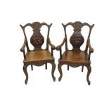 Pair of late 19th / early 20th century Chinese finely carved hardwood elbow chairs,