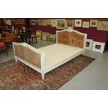 Late 19th / early 20th century French cream painted and double caned double bed with ribbon-carved