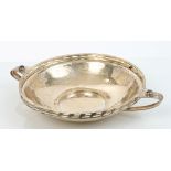 Early George V silver two-handled dish of circular form, with spot-hammered finish,