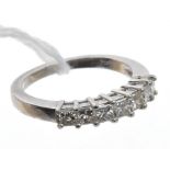 Diamond eternity ring with a line of seven princess cut diamonds in platinum setting