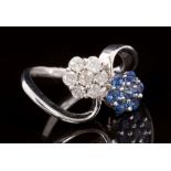 Diamond and sapphire crossover ring with two opposing flower-head clusters in white gold (18ct)