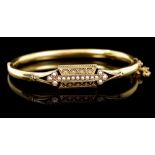 Victorian hinged bangle with a seed pearl and applied filigree panel, the reverse engraved 'Eva,