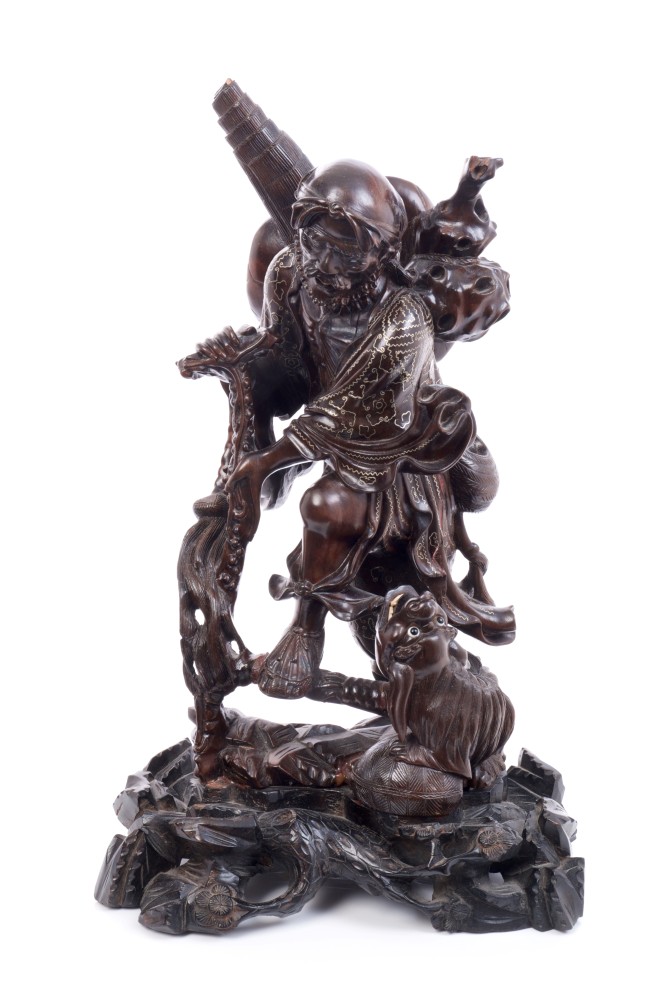 Late 19th century Chinese carved hardwood figure of a peasant with dog with white metal wire inlay