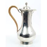 Victorian silver hot water jug of baluster form, with beak spout,