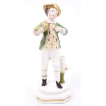 Early 19th century Staffordshire porcelain figure of a boy holding a bird's nest, circa 1830 - 1840,