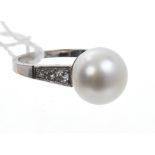 White gold (18ct) pearl and diamond ring with a central cultured pearl measuring approximately 10.