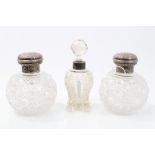 Pair Edwardian cut glass toilet bottles of globular form,