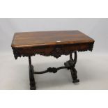 William IV rosewood card table with hinged rounded rectangular moulded top on shaped frieze and