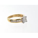 Diamond cluster ring with a square cluster of invisibly set princess cut diamonds,