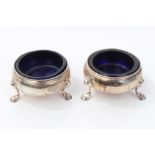 Pair George II silver cauldron salts on three hoof feet and with later blue glass liners (London