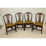 Set of four George III mahogany dining chairs,