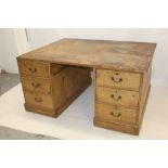 A substantial 19th century pine twin-pedestal partners desk with seven drawers to each knee-hole