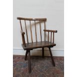 19th century ash and elm primitive elbow chair with stick back and solid seat on splayed supports