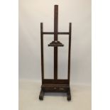 Good Victorian stained beech artists' easel of large size, adjusting on a screw,
