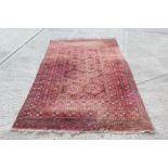 Pakistani Turkoman-style rug with rows of faceted medallions within multiple geometric borders,