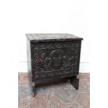 Antique oak box stool, relief carved with masks and geometric borders, on V-cut ends,