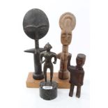 Group of African tribal figures - including a bronze figure on marble plinth,