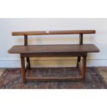 19th century pitch pine bench with plain top rail, on square section supports,
