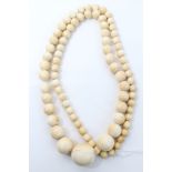 Victorian ivory bead necklace with graduating spherical beads, measuring from 8mm-25mm,