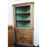 George III pine two height corner cupboard with dentil cornice and three shaped shelves with