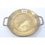 Art Nouveau brass two-handled dish with female relief profile and flanking vine entwined handles,