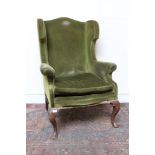 George II-style wing armchair with green velvet upholstery,