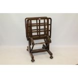 Early 20th century oak folio stand with adjustable lattice supports on H-shaped base and castors,