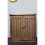 19th century pine cupboard enclosed by pair of panelled doors,