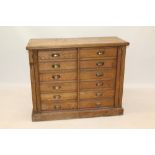 Late 19th century oak dual Wellington chest with two banks of six drawers between locking stiles,