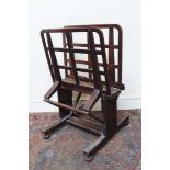 Early 20th century oak folio stand with adjustable lattice supports, on H-shaped base and castors,