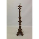 19th century Continental carved walnut standard lamp of knopped flared triangular form