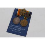 First World War pair - comprising War and Victory medals, together with a silver War badge,