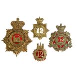 Three 12th (Suffolk) Regiment badges and QEII Suffolk Regiment blue cloth helmet plate (4)