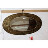 Arts & Crafts oval mirror with brass repoussé Celtic knot and sea dragon head wrythen decoration