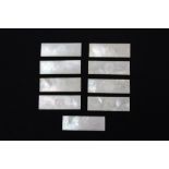 Nine rectangular mother of pearl gaming counters with initial M and floral decoration