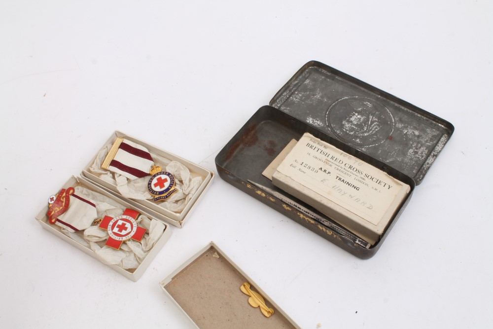 Boer War chocolate tin, together with four British Red Cross Society medals with boxes of issue,