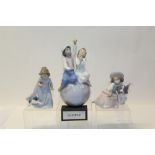 Two Lladro porcelain figures - boy and girl sitting on World globe and girl with dog,