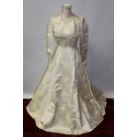 Circa 1950s wedding dress in cream satin silk damask in Lily of the Valley design,