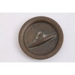First World War brass dish with raised decoration depicting a U Boat and stamped lettering 'U. C.