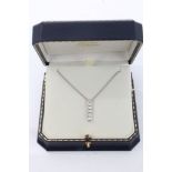 White gold (18ct) pendant set with a vertical line of five brilliant cut diamonds estimated to