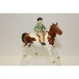 Beswick model of a girl on a skewbald pony,