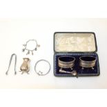 Pair George V silver salts of oval form, with pierced decoration and matching spoons,