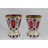 Pair of 19th century Bohemian overlaid glass vases with gilt rims and floral decoration,